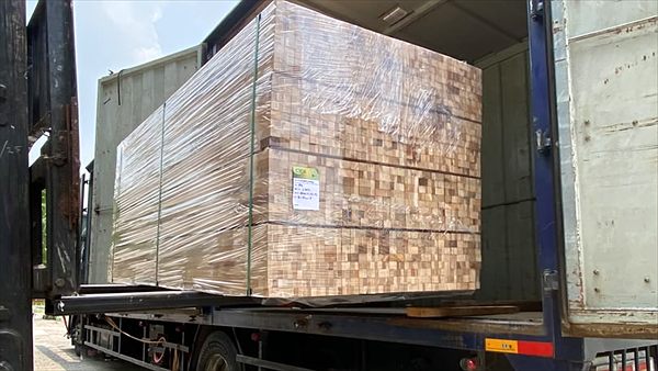 Shrink-wrapped and labelled pallet of finger-jointed board loaded on a lorry for delivery