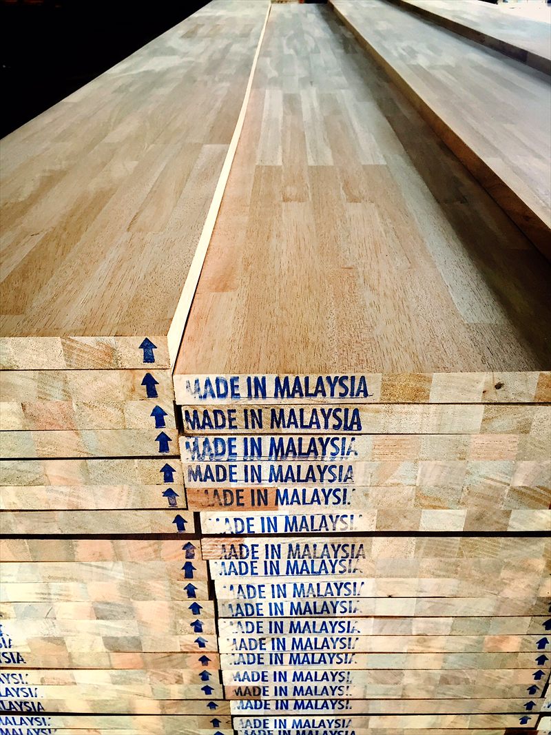 Stacked finger-jointed laminated boards marked Made in Malaysia